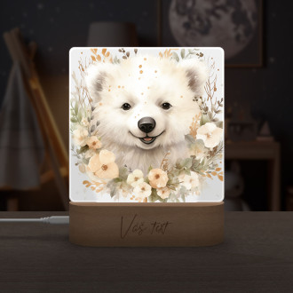 Polar bear cub in flowers