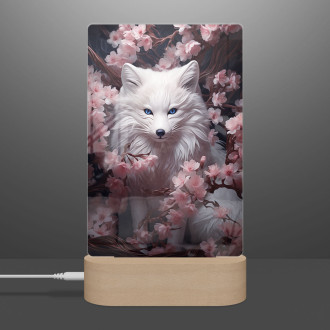 Lamp fox with blue eyes hiding in flowers